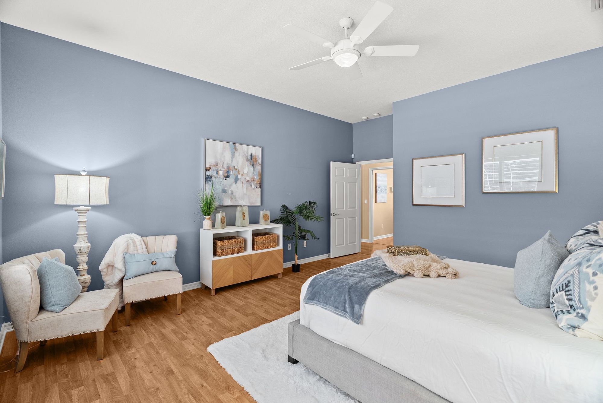 Bedroom with blue walls and a sitting area