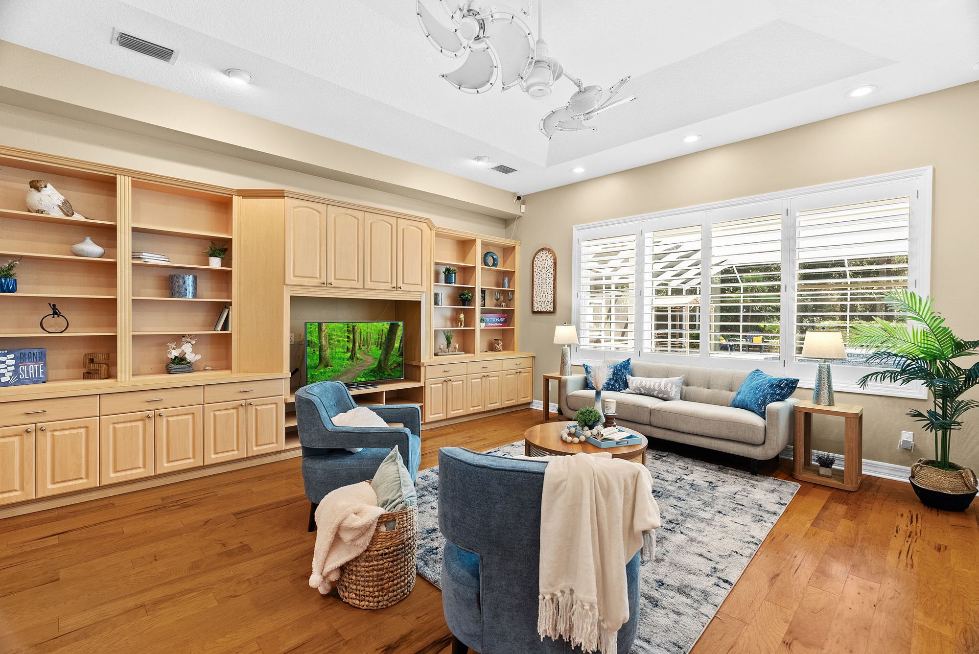 Family room with built-ins and plantation shutters