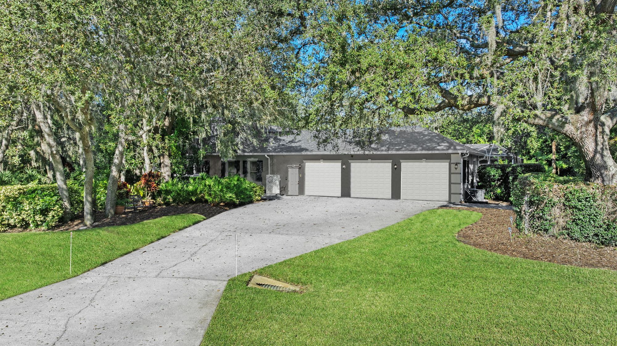 Three-car garage under mature oaks