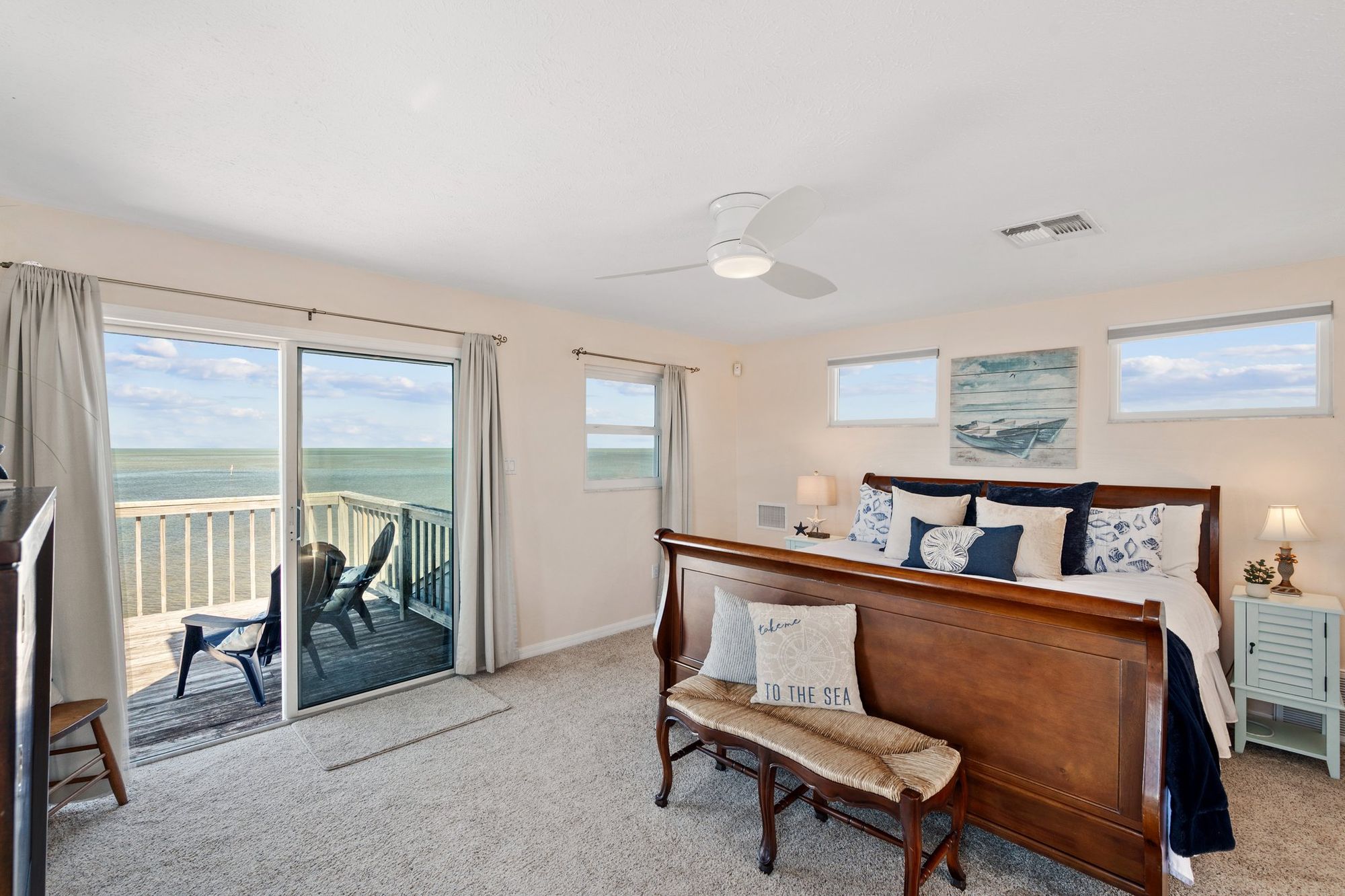 Bedroom opening onto a deck over the water