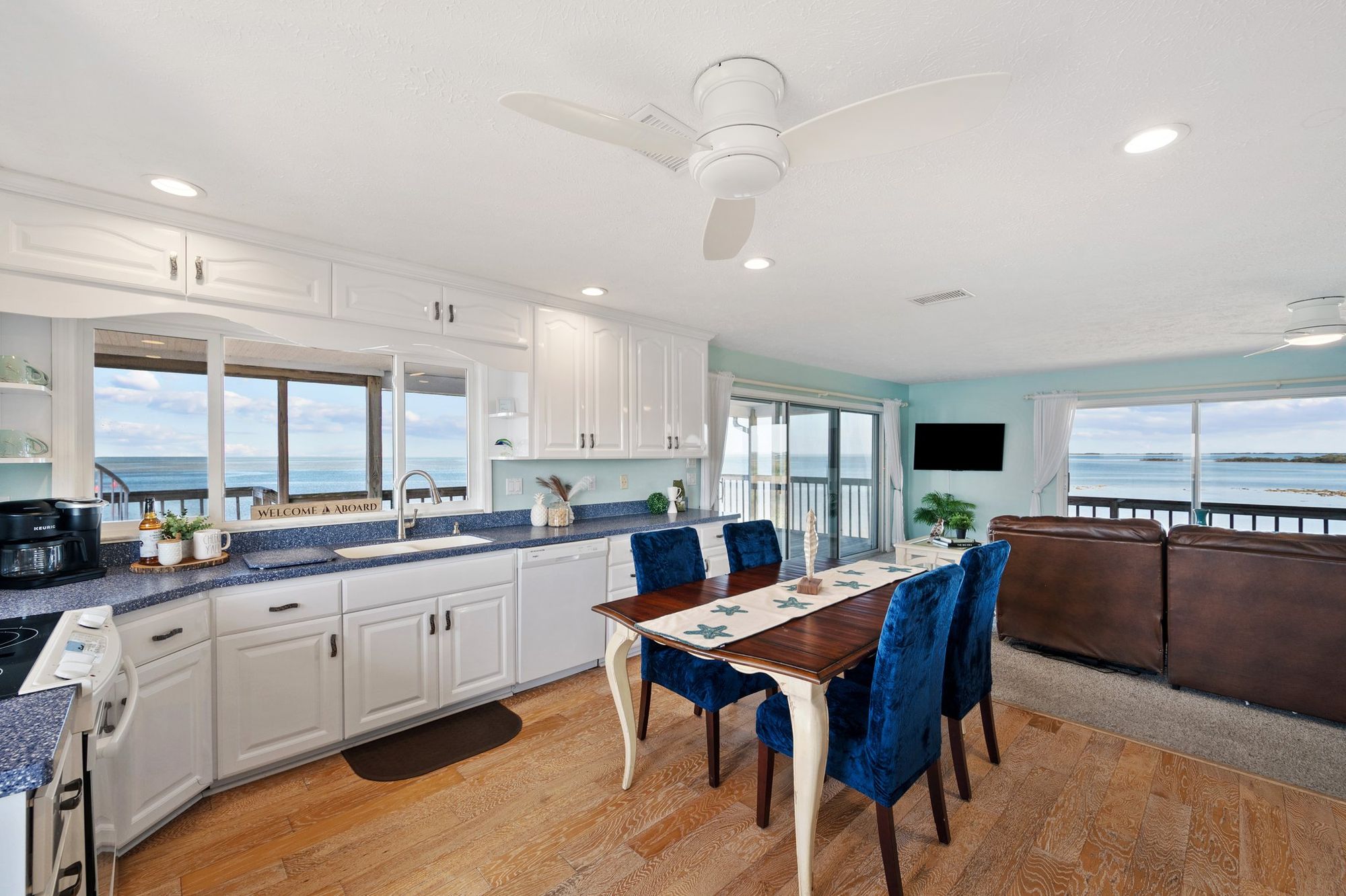 Open kitchen and living room with water on both sides