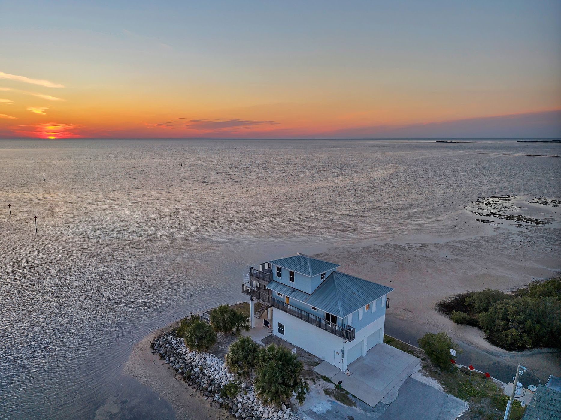 The house at dusk with the sun on the horizon